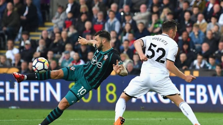 SWANSEA, WALES - MAY 08: Charlie Austin of Southampton takes a shot on goal under pressure from Connor Roberts of Swansea City during the Premier League match between Swansea City and Southampton at Liberty Stadium on May 8, 2018 in Swansea, Wales. (Photo by Dan Mullan/Getty Images)