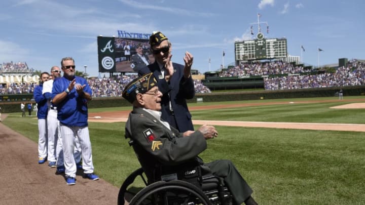 CHICAGO, IL - SEPTEMBER 03: World War II veteran Art Rento (front) is honored before the game between the Chicago Cubs and the Atlanta Braves on September 3, 2017 at Wrigley Field in Chicago, Illinois. (Photo by David Banks/Getty Images)