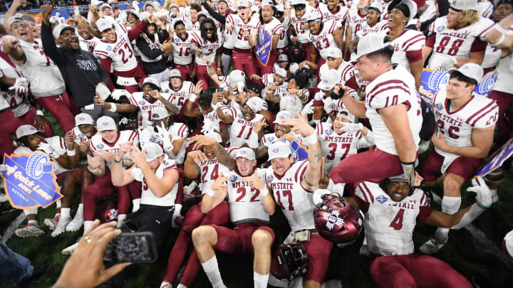 Dec 26, 2022; Detroit, Michigan, USA; New Mexico State University players celebrate their win over Bowling Green State University in the 2022 Quick Lane Bowl at Ford Field. Mandatory Credit: Lon Horwedel-USA TODAY Sports