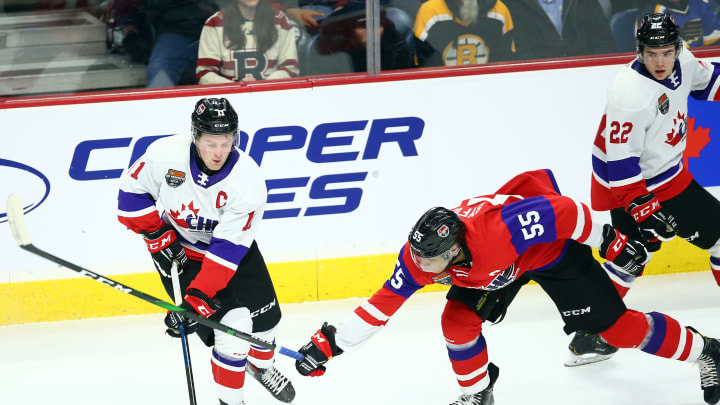 Alexis Lafreniere #11 of Team White and Quinton Byfield #55 of Team Red battle for the puck during the first period of the 2020 CHL/NHL Top Prospects Game.