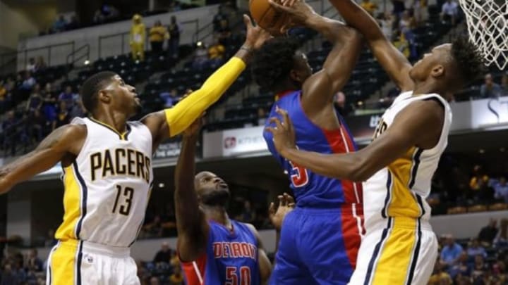 Oct 13, 2015; Indianapolis, IN, USA; Detroit Pistons forward Stanley Johnson (3) takes a shot against Indiana Pacers forward Paul George (13) and center Myles Turner (33) at Bankers Life Fieldhouse. Mandatory Credit: Brian Spurlock-USA TODAY Sports