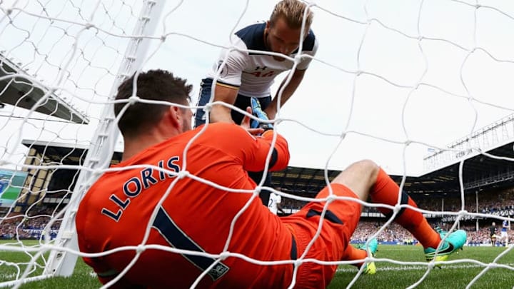 LIVERPOOL, ENGLAND - AUGUST 13: Harry Kane of Tottenham Hotspur helps Hugo Lloris of Tottenham Hotspur up during the Premier League match between Everton and Tottenham Hotspur at Goodison Park on August 13, 2016 in Liverpool, England. (Photo by Jan Kruger/Getty Images)