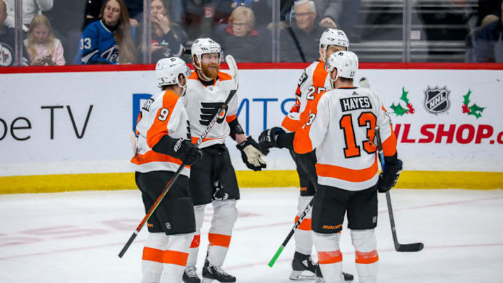 WINNIPEG, MB - DECEMBER 15: Ivan Provorov #9, Jakub Voracek #93, Kevin Hayes #13 and James van Riemsdyk #25 of the Philadelphia Flyers celebrate a second period goal against the Winnipeg Jets at the Bell MTS Place on December 15, 2019 in Winnipeg, Manitoba, Canada. (Photo by Jonathan Kozub/NHLI via Getty Images)