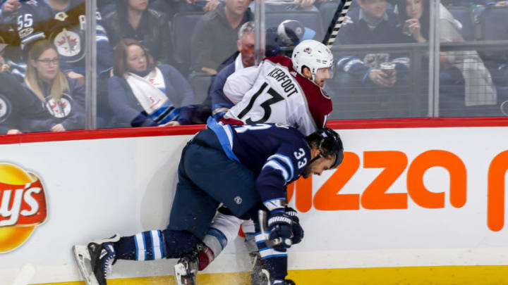 WINNIPEG, MB - NOVEMBER 9: Dustin Byfuglien #33 of the Winnipeg Jets checks Alexander Kerfoot #13 of the Colorado Avalanche into the boards during third period action at the Bell MTS Place on November 9, 2018 in Winnipeg, Manitoba, Canada. (Photo by Jonathan Kozub/NHLI via Getty Images)