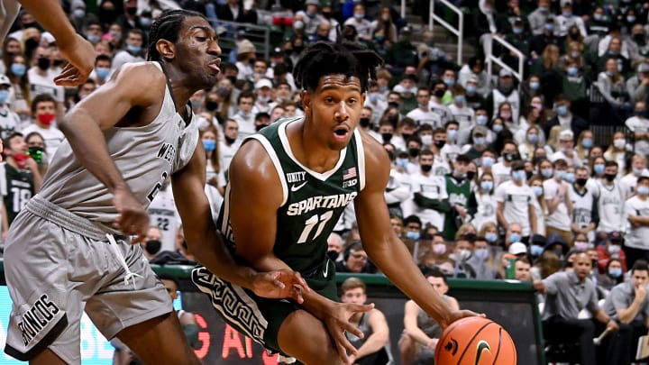 Nov 12, 2021; East Lansing, Michigan, USA; Michigan StateÕs AJ Hoggard(11) drives to the basket past Westernb MichiganÕs Adrian Martin(2) at Jack Breslin Student Events Center. Mandatory Credit: Dale Young-USA TODAY Sports