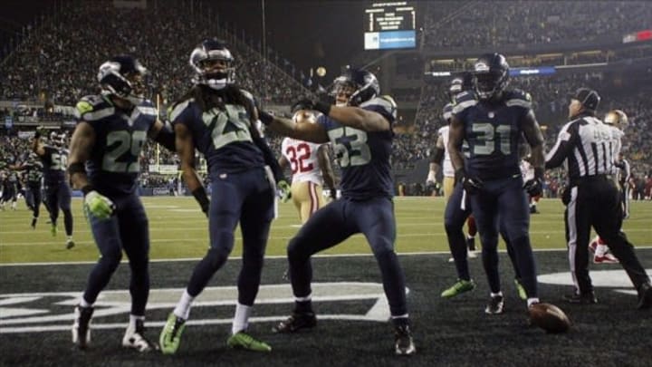 Jan 19, 2014; Seattle, WA, USA; (EDITORS NOTE: caption correction) Seattle Seahawks cornerback Richard Sherman (25) celebrates after tipping a pass to outside linebacker Malcolm Smith (53) for an interception in the fourth quarter of the 2013 NFC Championship football game against the San Francisco 49ers at CenturyLink Field. Mandatory Credit: Joe Nicholson-USA TODAY Sports