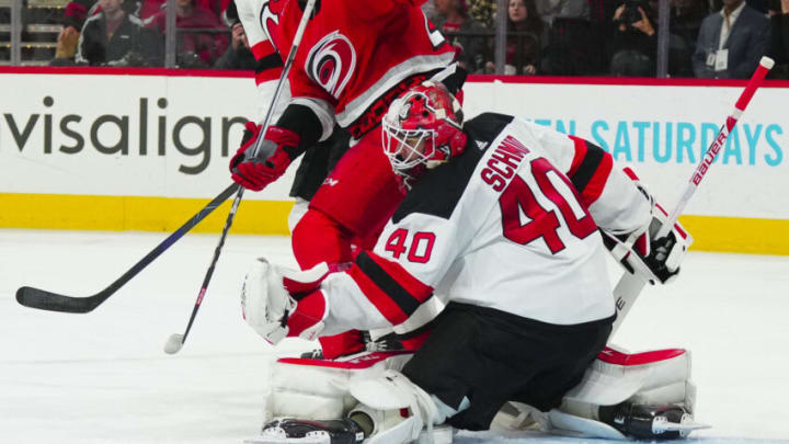 May 11, 2023; Raleigh, North Carolina, USA; New Jersey Devils goaltender Akira Schmid (40) makes a glove save against the Carolina Hurricanes during the third period in game five of the second round of the 2023 Stanley Cup Playoffs at PNC Arena. Mandatory Credit: James Guillory-USA TODAY Sports