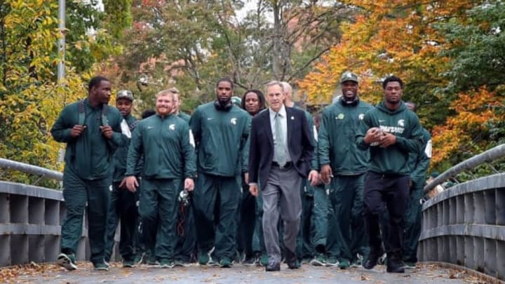Oct 24, 2015; East Lansing, MI, USA; Michigan State Spartans head coach Mark Dantonio and former Michigan State Spartan running back Jeremy Langford walk team to stadium prior to a game against the Indiana Hoosiers at Spartan Stadium. Mandatory Credit: Mike Carter-USA TODAY Sports