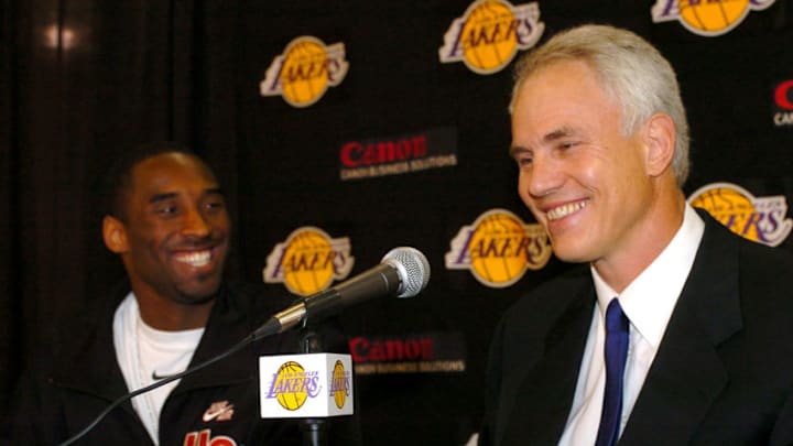 Los Angeles Lakers Kobe Bryant shakes hands with general manager Mitch Kupchak looks during a news conference Thursday, July 15, 2004, at the team's training facility in El Segundo, Calif.Bryant chose the Lakers over the Clippers, remaining with the team he joined in 1996 at age 18 and later helped win three NBA championships. (Photo by Steve Grayson/WireImage)