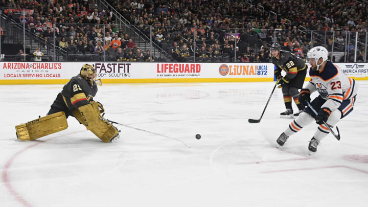 Marc-Andre Fleury of the Vegas Golden Knights comes out of the crease to poke check the puck to stop a breakaway by Riley Sheahan of the Edmonton Oilers in the third period of their game at T-Mobile Arena on February 26, 2020.