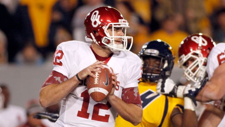 MORGANTOWN, WV – NOVEMBER 17: Landry Jones #12 of the Oklahoma Sooners drops back to pass against the West Virginia Mountaineers during the game on November 17, 2012 at Mountaineer Field in Morgantown, West Virginia. (Photo by Justin K. Aller/Getty Images)