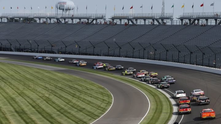 Jul 23, 2016; Indianapolis, IN, USA; NASCAR Xfinity drivers Kyle Busch (18) leads the field for the start of the Lilly Diabetes 250 at Indianapolis Motor Speedway. Mandatory Credit: Brian Spurlock-USA TODAY Sports