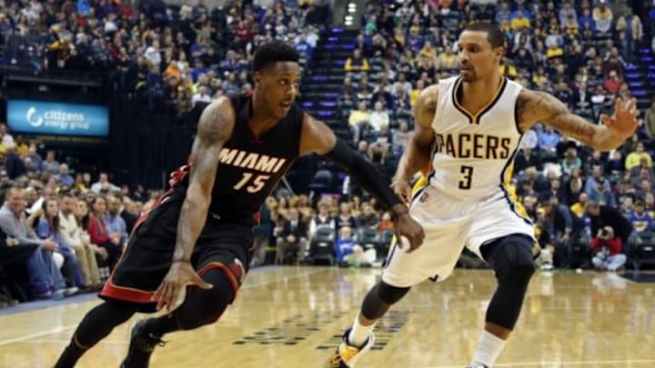 Dec 31, 2014; Indianapolis, IN, USA; Miami Heat guard Mario Chalmers (15) drives to the basket against Indiana Pacers guard George Hill (3) at Bankers Life Fieldhouse. Mandatory Credit: Brian Spurlock-USA TODAY Sports