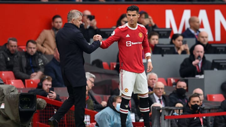 Manchester United's Norwegian manager Ole Gunnar Solskjaer (L) shakes hands with Manchester United's Portuguese striker Cristiano Ronaldo as he comes off the substitutes bench during the English Premier League football match between Manchester United and Everton at Old Trafford in Manchester, north west England, on October 2, 2021. - RESTRICTED TO EDITORIAL USE. No use with unauthorized audio, video, data, fixture lists, club/league logos or 'live' services. Online in-match use limited to 120 images. An additional 40 images may be used in extra time. No video emulation. Social media in-match use limited to 120 images. An additional 40 images may be used in extra time. No use in betting publications, games or single club/league/player publications. (Photo by Oli SCARFF / AFP) / RESTRICTED TO EDITORIAL USE. No use with unauthorized audio, video, data, fixture lists, club/league logos or 'live' services. Online in-match use limited to 120 images. An additional 40 images may be used in extra time. No video emulation. Social media in-match use limited to 120 images. An additional 40 images may be used in extra time. No use in betting publications, games or single club/league/player publications. / RESTRICTED TO EDITORIAL USE. No use with unauthorized audio, video, data, fixture lists, club/league logos or 'live' services. Online in-match use limited to 120 images. An additional 40 images may be used in extra time. No video emulation. Social media in-match use limited to 120 images. An additional 40 images may be used in extra time. No use in betting publications, games or single club/league/player publications. (Photo by OLI SCARFF/AFP via Getty Images)