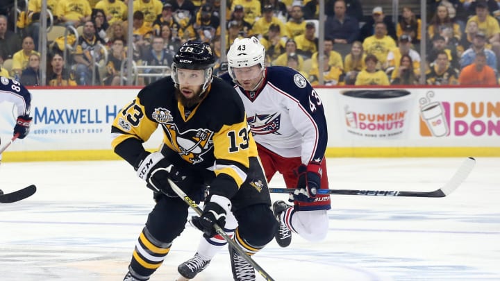 Apr 12, 2017; Pittsburgh, PA, USA; Pittsburgh Penguins center Nick Bonino (13) moves the puck ahead of Columbus Blue Jackets left wing Scott Hartnell (43) during the second period in game one of the first round of the 2017 Stanley Cup Playoffs at PPG PAINTS Arena. The Penguins won 3-1. Mandatory Credit: Charles LeClaire-USA TODAY Sports