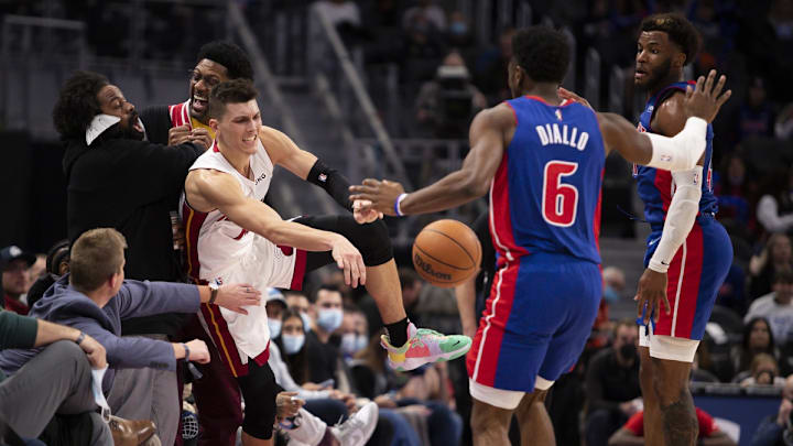 Nov 23, 2021; Detroit, Michigan, USA; Miami Heat guard Tyler Herro (14) falls out of bounds near sports analyst Jalen Rose (glasses) as he is defended by Detroit Pistons guard Hamidou Diallo (6) and forward Saddiq Bey (41) during the fourth quarter at Little Caesars Arena. Mandatory Credit: Raj Mehta-USA TODAY Sports Nov 23, 2021; Detroit, Michigan, USA; Miami Heat guard Tyler Herro (14) falls out of bounds near sports analyst Jalen Rose (glasses) as he is defended by Detroit Pistons guard Hamidou Diallo (6) and forward Saddiq Bey (41) during the fourth quarter at Little Caesars Arena. Mandatory Credit: Raj Mehta-USA TODAY Sports