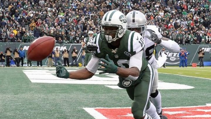 Dec 8, 2013; East Rutherford, NJ, USA; New York Jets wide receiver Santonio Holmes (10) is unable to catch a pass in the end zone against Oakland Raiders cornerback Phillip Adams (28) in the first half during the game at MetLife Stadium. Mandatory Credit: Robert Deutsch-USA TODAY Sports