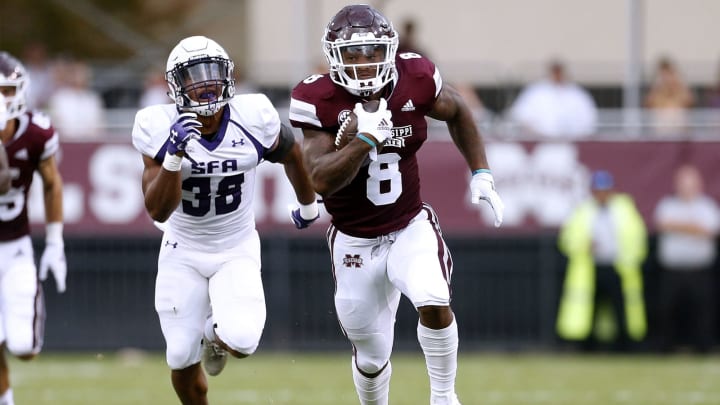 STARKVILLE, MS – SEPTEMBER 01: Kylin Hill #8 of the Mississippi State Bulldogs scores a touchdown as Trenton Gordon #38 of the Stephen F. Austin Lumberjacks defends during the first half at Davis Wade Stadium on September 1, 2018 in Starkville, Mississippi. (Photo by Jonathan Bachman/Getty Images)