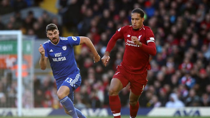 LIVERPOOL, ENGLAND - OCTOBER 27: Virgil van Dijk of Liverpool runs with the ball under pressure from Callum Paterson of Cardiff City during the Premier League match between Liverpool FC and Cardiff City at Anfield on October 27, 2018 in Liverpool, United Kingdom. (Photo by Jan Kruger/Getty Images)