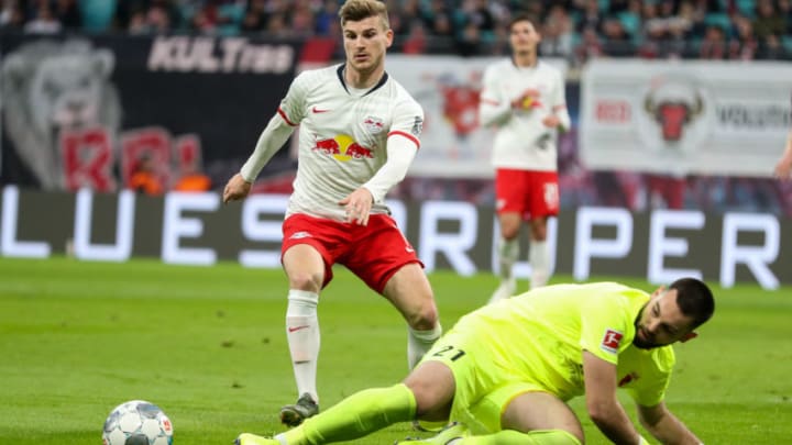 21 December 2019, Saxony, Leipzig: Football: Bundesliga, 17th matchday, RB Leipzig - FC Augsburg in the Red Bull Arena. Augsburg goalkeeper Tomas Koubek (r) misses against Leipzig's Timo Werner. Photo: Jan Woitas/dpa-Zentralbild/dpa - IMPORTANT NOTE: In accordance with the regulations of the DFL Deutsche Fußball Liga and the DFB Deutscher Fußball-Bund, it is prohibited to exploit or have exploited in the stadium and/or from the game taken photographs in the form of sequence images and/or video-like photo series. (Photo by Jan Woitas/picture alliance via Getty Images)