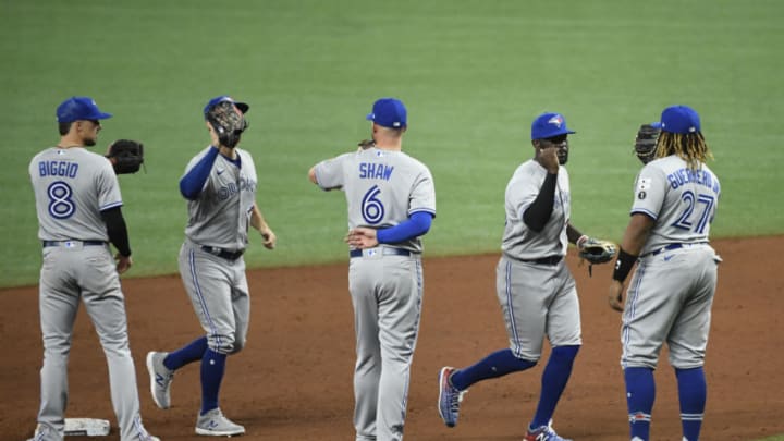 ST PETERSBURG, FLORIDA - JULY 24: Cavan Biggio #8 of the Toronto Blue Jays, Travis Shaw #6, and Vladimir Guerrero Jr. #27 celebrate with teammates after defeating the Tampa Bay Rays on Opening Day at Tropicana Field on July 24, 2020 in St Petersburg, Florida. The 2020 season had been postponed since March due to the COVID-19 pandemic. (Photo by Douglas P. DeFelice/Getty Images)