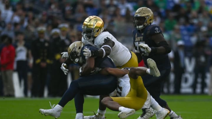 Nov 12, 2022; Baltimore, Maryland, USA; Notre Dame Fighting Irish safety Ramon Henderson (11) and Irish linebacker Marist Liufau (8) tackle Navy Midshipmen fullback Daba Fofana (45) during the second half at M&T Bank Stadium. Mandatory Credit: Tommy Gilligan-USA TODAY Sports