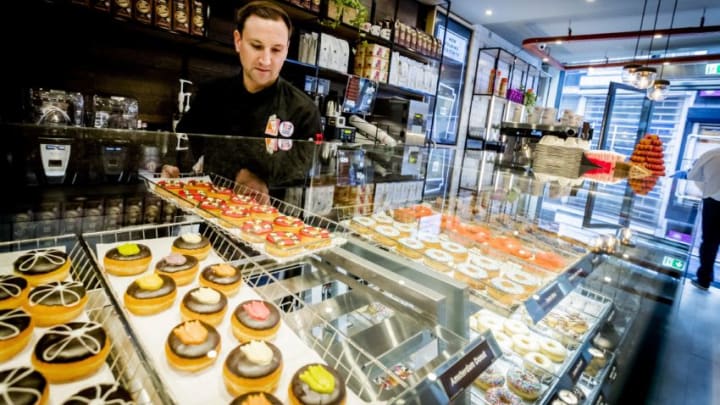 Donut brand Dunkin' Donuts prepares for the opening of the first store in Amsterdam, on March 22, 2017.The Dunkin' Donuts store will open on March 23rd, seventeen years after the last brandstore closed in the Netherlands. / AFP PHOTO / www.anpfoto.nl AND ANP / Remko de Waal / Netherlands OUT (Photo credit should read REMKO DE WAAL/AFP/Getty Images)