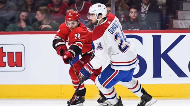 MONTREAL, QC - DECEMBER 13: Carolina Hurricanes center Sebastian Aho (20) tries to stop Montreal Canadiens center Phillip Danault (24) during the Carolina Hurricanes versus the Montreal Canadiens game on December 13, 2018, at Bell Centre in Montreal, QC (Photo by David Kirouac/Icon Sportswire via Getty Images)