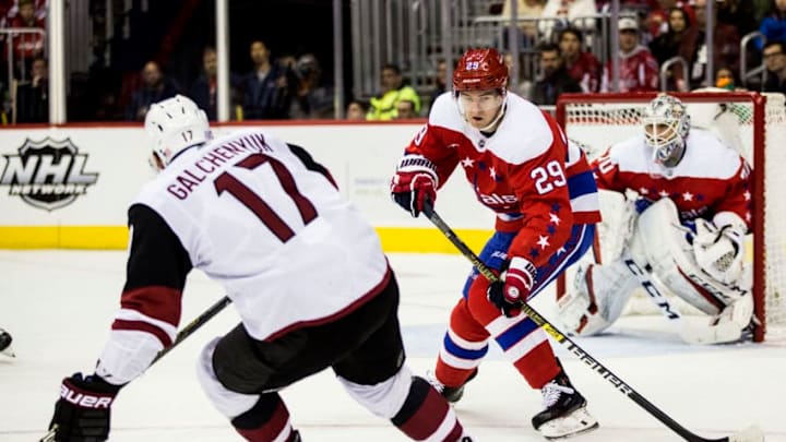 WASHINGTON, DC - NOVEMBER 11: Washington Capitals defenseman Christian Djoos (29) sends the puck past Arizona Coyotes center Alex Galchenyuk (17) during a NHL game between the Washington Capitals and the Arizona Coyotes on November 11, 2018, at Capital One Arena, in Washington, D.C.The Coyotes defeated the Capitals 4-1.(Photo by Tony Quinn/Icon Sportswire via Getty Images)