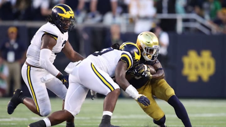 SOUTH BEND, IN - SEPTEMBER 01: Devin Bush #10 of the Michigan Wolverines tackles Jafar Armstrong #8 of the Notre Dame Fighting Irish in the first quarter at Notre Dame Stadium on September 1, 2018 in South Bend, Indiana. (Photo by Gregory Shamus/Getty Images)