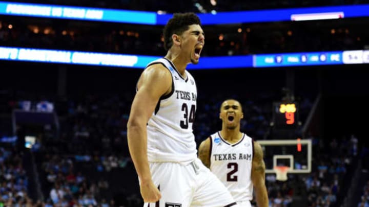 CHARLOTTE, NC – MARCH 16: Tyler Davis #34 and teammate T.J. Starks #2 of the Texas A&M Aggies react after a score in their game against the Providence Friars during the first round of the 2018 NCAA Men’s Basketball Tournament at Spectrum Center on March 16, 2018 in Charlotte, North Carolina. (Photo by Jared C. Tilton/Getty Images)