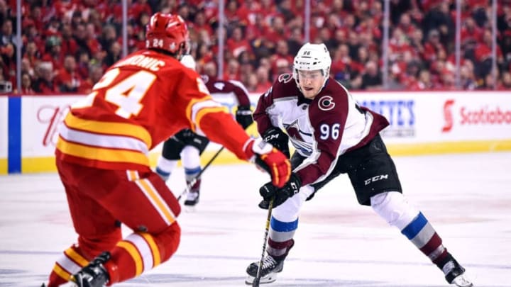 CALGARY, AB - APRIL 13: Colorado Avalanche Right Wing Mikko Rantanen (96) skates with the puck over the blue line as Calgary Flames Defenceman Travis Hamonic (24) defends his zone during the first period of Game Two of the Western Conference First Round during the 2019 Stanley Cup Playoffs where the Calgary Flames hosted the Colorado Avalanche on April 13, 2019, at the Scotiabank Saddledome in Calgary, AB. (Photo by Brett Holmes/Icon Sportswire via Getty Images)