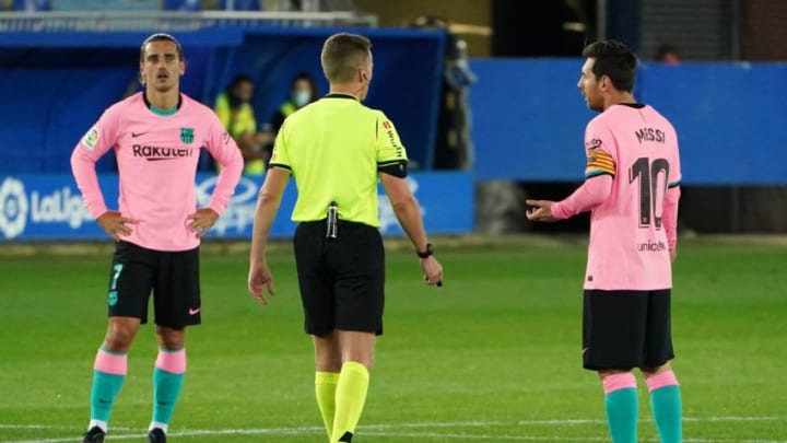 Barcelona's Argentine forward Lionel Messi (R) talks to Spanish referee Alejandro Hernandez Hernandez after receiving a yellow card during the Spanish League football match between Deportivo Alaves and Barcelona at the Mendizorroza stadium in Vitoria on October 31, 2020. (Photo by Cesar Manso / AFP) (Photo by CESAR MANSO/AFP via Getty Images)