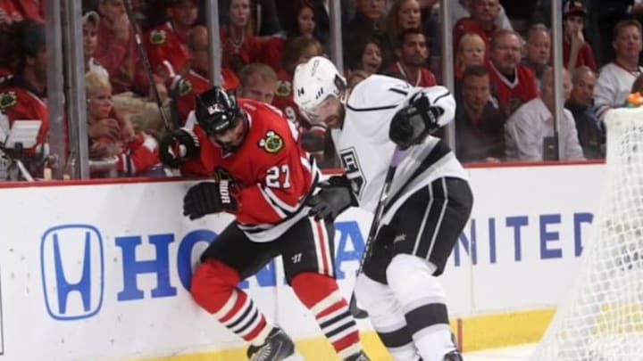 May 28, 2014; Chicago, IL, USA; Chicago Blackhawks defenseman Johnny Oduya (27) battles for the puck with Los Angeles Kings right wing Justin Williams (14) during the third period in game five of the Western Conference Final of the 2014 Stanley Cup Playoffs at United Center. Mandatory Credit: Jerry Lai-USA TODAY Sports