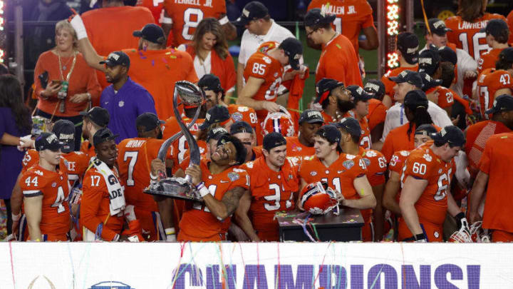 ARLINGTON, TEXAS - DECEMBER 29: Isaiah Simmons #11 of the Clemson Tigers celebrates with the trophy after defeating the Notre Dame Fighting Irish during the College Football Playoff Semifinal Goodyear Cotton Bowl Classic at AT&T Stadium on December 29, 2018 in Arlington, Texas. Clemson defeated Notre Dame 30-3. (Photo by Tim Warner/Getty Images)