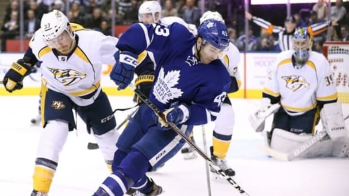 Nov 15, 2016; Toronto, Ontario, CAN; Toronto Maple Leafs center Nazem Kadri (43) tries to control the puck against the Nashville Predators at Air Canada Centre. Mandatory Credit: Tom Szczerbowski-USA TODAY Sports