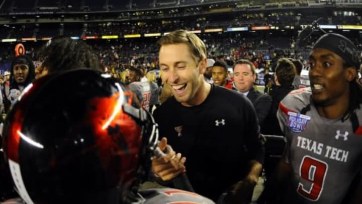 Dec 30, 2013; San Diego, CA, USA; Texas Tech Red Raiders head coach Kliff Kingsbury celebrates with players after a win against the Arizona State Sun Devils in the Holiday Bowl at Qualcomm Stadium. Texas Tech won 37-23. Mandatory Credit: Christopher Hanewinckel-USA TODAY Sports