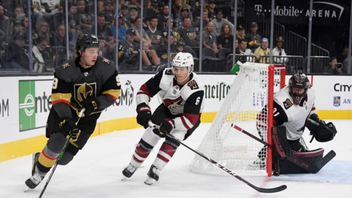 LAS VEGAS, NEVADA - SEPTEMBER 15: Cody Glass #9 of the Vegas Golden Knights skates with the puck against Jakob Chychrun #6 of the Arizona Coyotes as Adin Hill #31 of the Coyotes tends net in the second period of their preseason game at T-Mobile Arena on September 15, 2019 in Las Vegas, Nevada. The Golden Knights defeated the Coyotes 6-2. (Photo by Ethan Miller/Getty Images)
