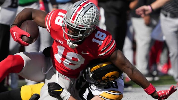 Oct 22, 2022; Columbus, Ohio, USA; Ohio State Buckeyes wide receiver Marvin Harrison Jr. (18) is tackled by Iowa Hawkeyes linebacker Greg Fagan (38) in the NCAA Division I football game between the Ohio State Buckeyes and the Iowa Hawkeyes at Ohio Stadium. Mandatory Credit: Brooke LaValley/Columbus DispatchNcaa Football Iowa Hawkeyes At Ohio State Buckeyes Oct 22, 2022; Columbus, Ohio, USA; Ohio State Buckeyes wide receiver Marvin Harrison Jr. (18) is tackled by Iowa Hawkeyes linebacker Greg Fagan (38) in the NCAA Division I football game between the Ohio State Buckeyes and the Iowa Hawkeyes at Ohio Stadium. Mandatory Credit: Brooke LaValley/Columbus DispatchNcaa Football Iowa Hawkeyes At Ohio State Buckeyes