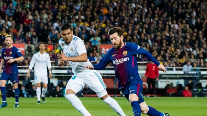 BARCELONA, SPAIN - MAY 06: Lionel Andres Messi (R) of FC Barcelona fights for the ball with Carlos Henrique Casemiro of Real Madrid during the La Liga match between Barcelona and Real Madrid at Camp Nou on May 6, 2018 in Barcelona, Spain. (Photo by Power Sport Images/Getty Images)