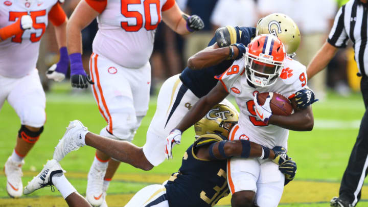 ATLANTA, GA - SEPTEMBER 22: Travis Etienne #9 of the Clemson Tigers is tackled by Lamont Simmons #6 and Malik Rivera #36 of the Georgia Tech Yellow Jackets on September 22, 2018 in Atlanta, Georgia. (Photo by Scott Cunningham/Getty Images)