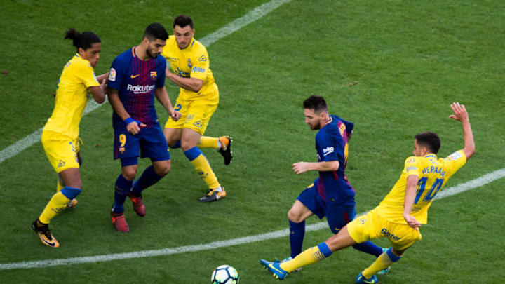 BARCELONA, SPAIN - OCTOBER 01: Lionel Messi of FC Barcelona advances with the ball under pressure from Hernan Santana of UD Las Palmas during the La Liga match between Barcelona and Las Palmas at Camp Nou on October 1, 2017 in Barcelona, Spain. The match is being played with empty stands after the events occured in Catalonia during the voting of a Catalonia independence referendum declared illegal and undemocratic by the Spanish government. (Photo by Alex Caparros/Getty Images)