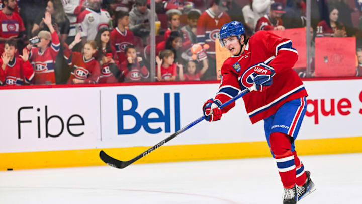 Sep 30, 2023; Montreal, Quebec, CAN; Montreal Canadiens defenseman David Reinbacher (64) shoots a puck during warm-up before the game against the Toronto Maple Leafs at Bell Centre. Mandatory Credit: David Kirouac-USA TODAY Sports