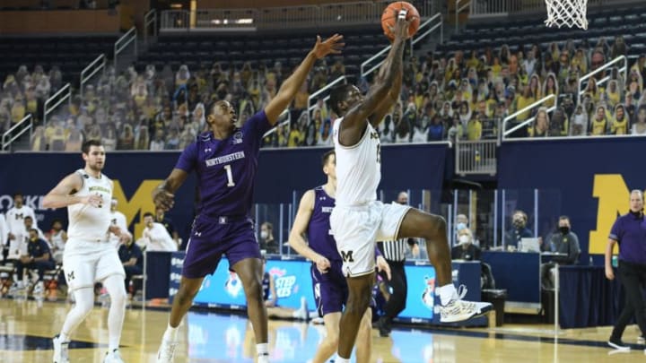 Jan 3, 2021; Ann Arbor, Michigan, USA; Michigan Wolverines guard Chaundee Brown (15) goes up for a slam dunk as Michigan Wolverines center Hunter Dickinson (1) defends during the first half at Crisler Center. Mandatory Credit: Tim Fuller-USA TODAY Sports