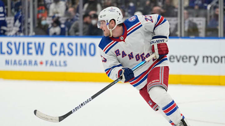 Oct 18, 2021; Toronto, Ontario, CAN; New York Rangers defenseman Adam Fox (23) skates with the puck against the Toronto Maple Leafs during overtime at Scotiabank Arena. Mandatory Credit: John E. Sokolowski-USA TODAY Sports