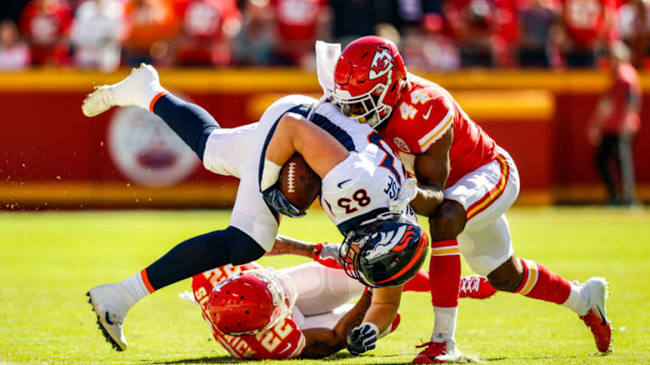 KANSAS CITY, MO - OCTOBER 28: Matt LaCosse #83 of the Denver Broncos is upended by Dorian O'Daniel #44 and teammate Orlando Scandrick #22 of the Kansas City Chiefs during the first half of the game at Arrowhead Stadium on October 28, 2018 in Kansas City, Missouri. (Photo by David Eulitt/Getty Images)