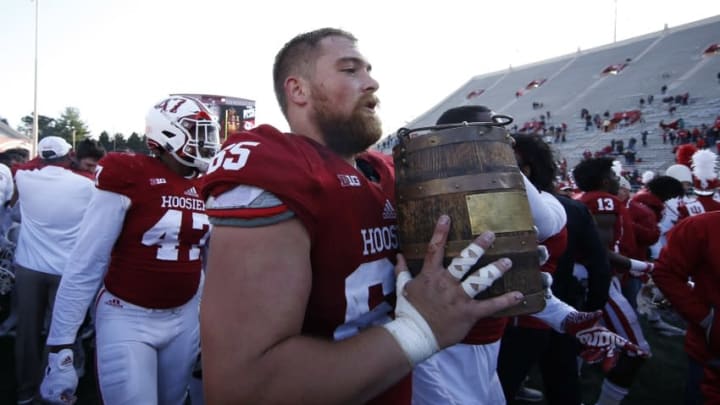 Nov 26, 2016; Bloomington, IN, USA; Indiana Hoosiers offensive lineman Wes Rogers (65) carries the Old Oaken Bucket to the locker room after the game against the Purdue Boilermakers at Memorial Stadium. Indiana defeats Purdue 26-24. Mandatory Credit: Brian Spurlock-USA TODAY Sports