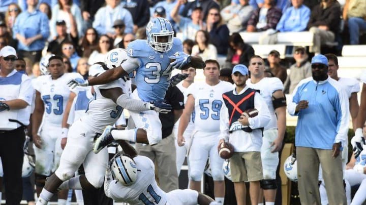 Nov 19, 2016; Chapel Hill, NC, USA; North Carolina Tar Heels running back Elijah Hood (34) with the ball as Citadel Bulldogs linebacker Myles Pierce (50) and defensive back Ben Roberts (11) defend in the first quarter at Kenan Memorial Stadium. Mandatory Credit: Bob Donnan-USA TODAY Sports
