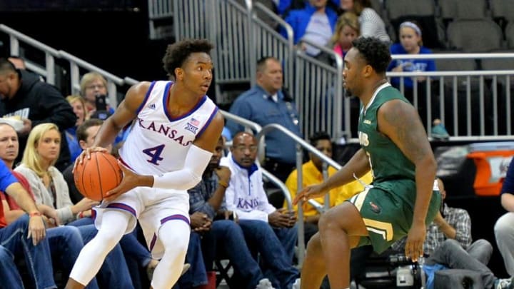 Nov 21, 2016; Kansas City, MO, USA; Kansas Jayhawks guard Devonte' Graham (4) looks to pass as UAB Blazers guard Denzell Watts (1) defends during the second half at Sprint Center. Kansas won 83-63. Mandatory Credit: Denny Medley-USA TODAY Sports