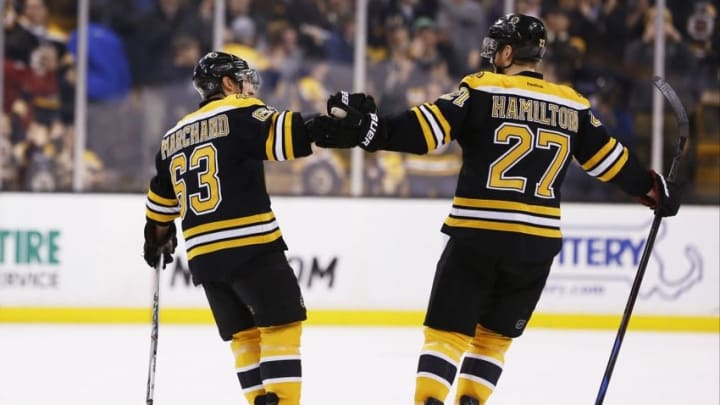 Mar 12, 2015; Boston, MA, USA; Boston Bruins defenseman Dougie Hamilton (27) congratulates left wing Brad Marchand (63) after he scored the game winning goal in a shootout against the Tampa Bay Lightning at TD Banknorth Garden. The Boston Bruins won 3-2 in a shootout. Mandatory Credit: Greg M. Cooper-USA TODAY Sports